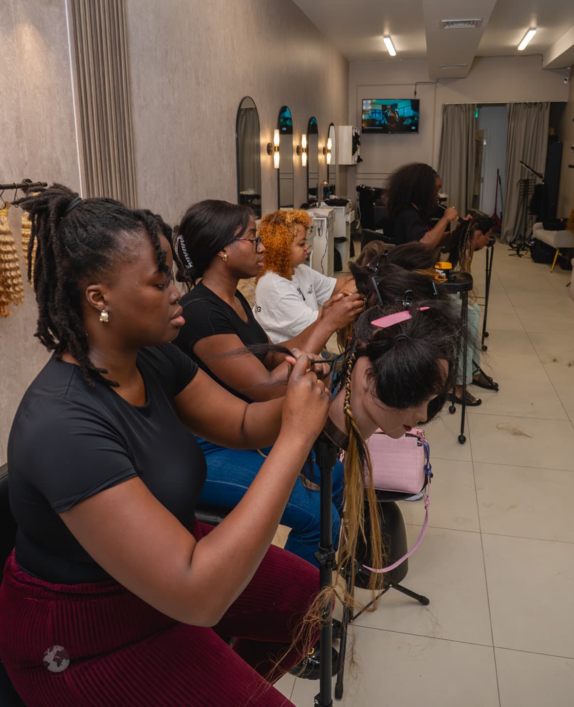 A small group of students working together at a Nattes braiding class
